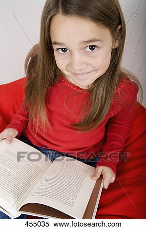 Young girl reading a book View Large Photo Image Stock Photography - Young girl reading a book. Fotosearch