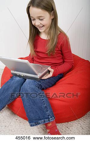 Young girl with portable DVD player View Large Photo Image Stock Photograph - Young girl with portable DVD player. Fotosearch
