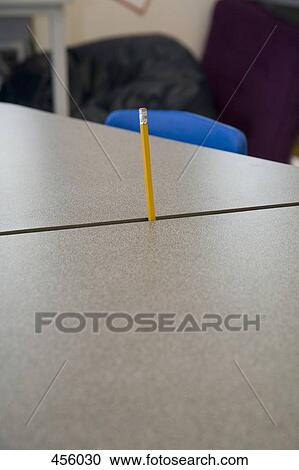 A pencil stuck between two desks View Large Photo Image Stock Image - A pencil stuck between two desks. Fotosearch