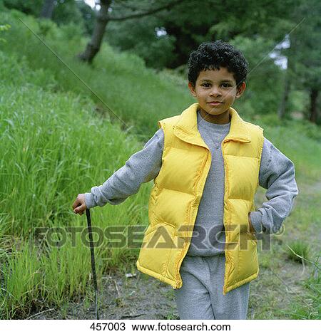 Boy posing with a walking stick View Large Photo Image Stock Image - Boy posing with a walking stick. Fotosearch