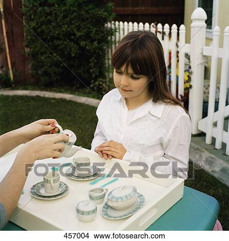 Children having a tea party in the garden View Large Photo Image Picture - Children having a tea party in the garden. Fotosearch
