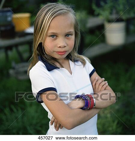 Stock Photo - Girl standing with her arms folded. Fotosearch