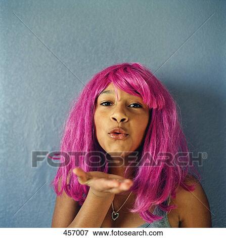 Teenage girl wearing a pink wig and blowing a kiss View Large Photo Image Stock Photo - Teenage girl wearing a pink wig and blowing a kiss. Fotosearch