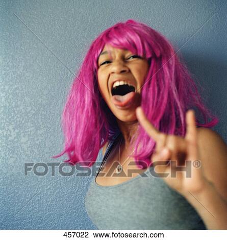 Teenage girl wearing a pink wig View Large Photo Image Stock Image - Teenage girl wearing a pink wig. Fotosearch