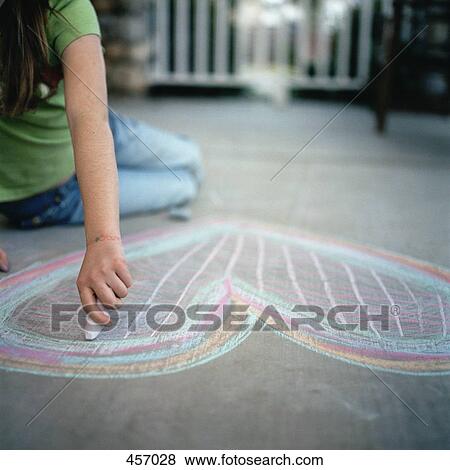 Young girl drawing a heart in chalk View Large Photo Image Stock Photo - Young girl drawing a heart in chalk. Fotosearch