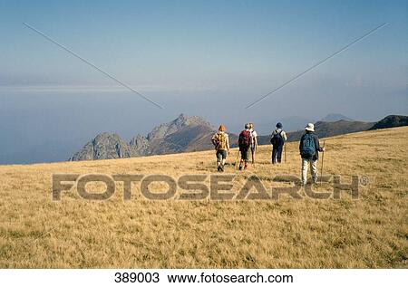 Group of people hiking along a mountain ridge View Large Photo Image Stock Image - Group of people hiking along a mountain ridge. Fotosearch