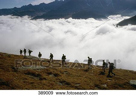 Group of people hiking in mountains View Large Photo Image Stock Photo - Group of people hiking in mountains. Fotosearch