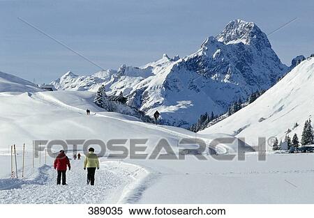 People walking on pathway through snowcapped mountains View Large Photo Image Stock Photography - People walking on pathway through snowcapped mountains. Fotosearch