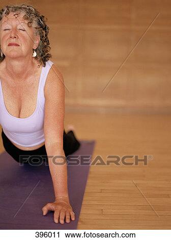 Stock Image - Woman in the cobra pose. Fotosearch