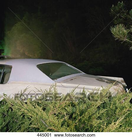 Stock Image - Car parked in a driveway at night. Fotosearch