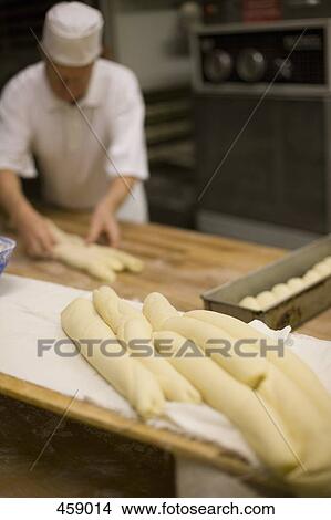 Picture - A man preparing dough for baking. Fotosearch