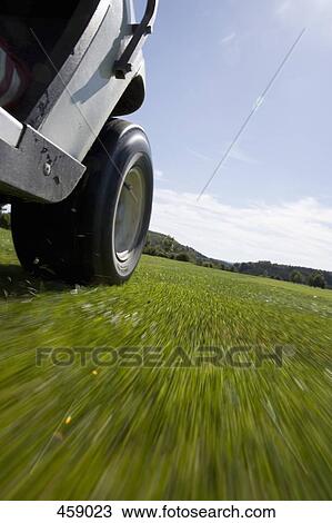 Low angle view of a golf cart driving on a golf course View Large Photo Image Stock Image - Low angle view of a golf cart driving on a golf course. Fotosearch