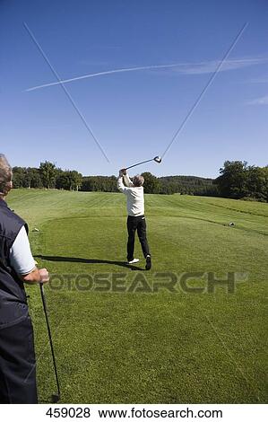 Rear view of a man teeing off View Large Photo Image Stock Photo - Rear view of a man teeing off. Fotosearch