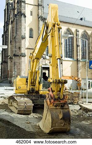 A digger outside of a church View Large Photo Image Picture - A digger outside of a church. Fotosearch