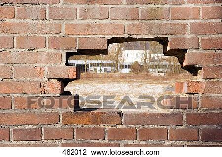 A hole in a brick wall View Large Photo Image Stock Image - A hole in a brick wall. Fotosearch