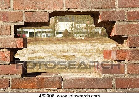 A hole in a brick wall View Large Photo Image Stock Photograph - A hole in a brick wall. Fotosearch