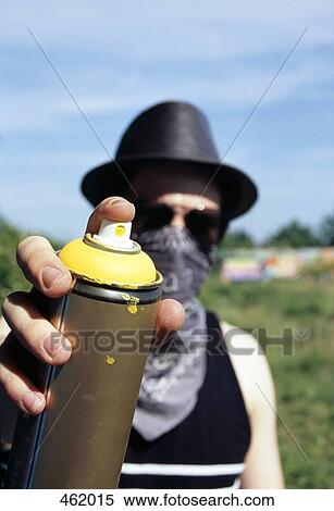 A man holding a can of spray paint View Large Photo Image Stock Photography - A man holding a can of spray paint. Fotosearch