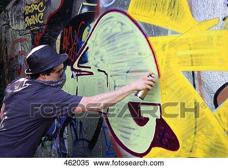 A man spraying paint on a wall View Large Photo Image Stock Photography - A man spraying paint on a wall. Fotosearch