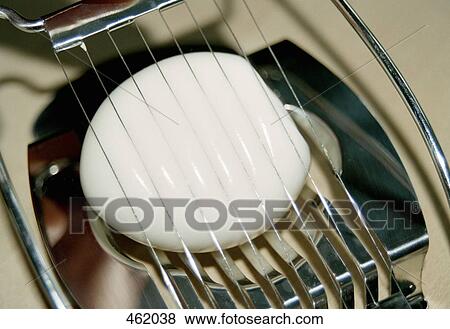 An egg being sliced View Large Photo Image Stock Photo - An egg being sliced. Fotosearch