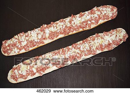 Two baguette halves with onion and meat View Large Photo Image Stock Photo - Two baguette halves with onion and meat. Fotosearch