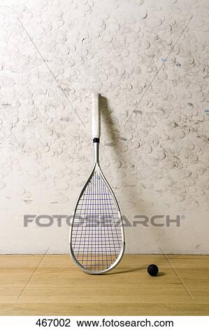 Stock Image - A squash racquet and ball. Fotosearch