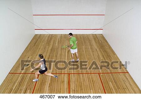High angle view of two people playing squash View Large Photo Image Stock Photo - High angle view of two people playing squash. Fotosearch