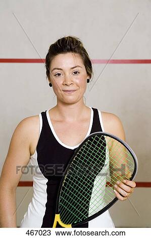 Portrait of a woman holding a squash racquet View Large Photo Image Stock Image - Portrait of a woman holding a squash racquet. Fotosearch