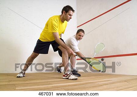 Two men playing squash View Large Photo Image Stock Image - Two men playing squash. Fotosearch