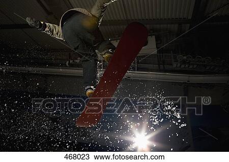 Snowboarder jumping mid-air View Large Photo Image Stock Image - Snowboarder jumping mid-air. Fotosearch