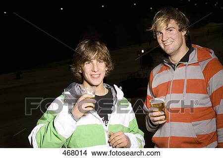 Picture - Two young men drinking beer. Fotosearch