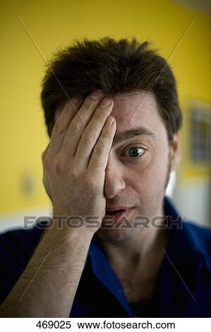A man covering one eye with his hand View Large Photo Image Stock Photography - A man covering one eye with his hand. Fotosearch