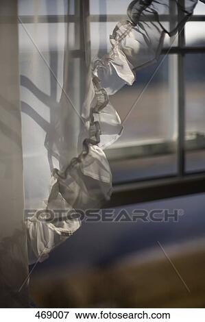 Stock Photo - Detail of a curtain in front of a window. Fotosearch