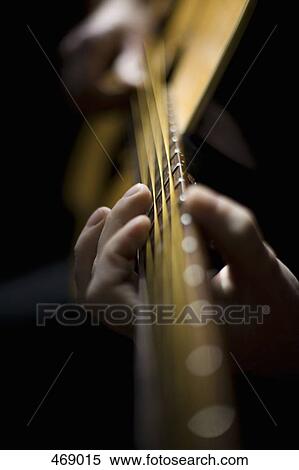 Detail of a man playing an acoustic guitar View Large Photo Image Stock Photography - Detail of a man playing an acoustic guitar. Fotosearch
