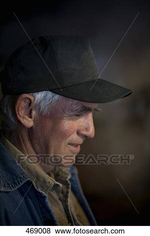 Side view of a senior man wearing a trucker cap View Large Photo Image Stock Photo - Side view of a senior man wearing a trucker cap. Fotosearch