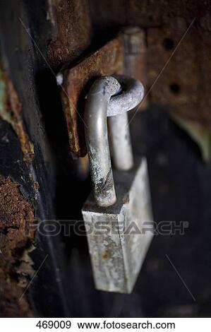 Silver padlock on a rusty door View Large Photo Image Stock Photo - Silver padlock on a rusty door. Fotosearch