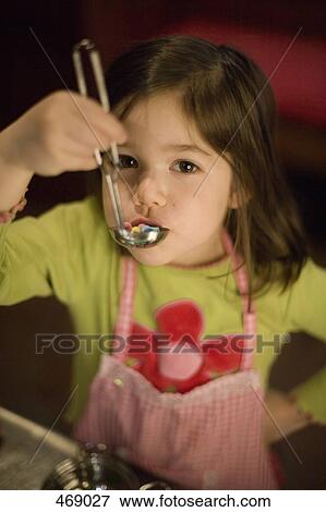 Young girl playing with a toy soup ladle View Large Photo Image Stock Photo - Young girl playing with a toy soup ladle. Fotosearch