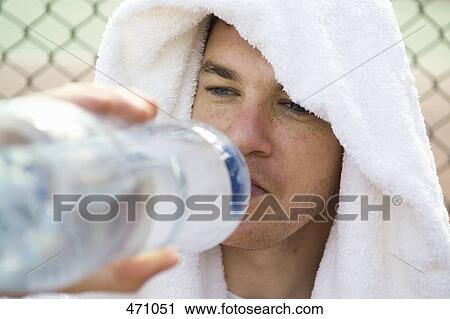 A man drinking from a water bottle View Large Photo Image Stock Image - A man drinking from a water bottle. Fotosearch