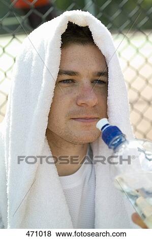 A man drinking from a water bottle View Large Photo Image Stock Photo - A man drinking from a water bottle. Fotosearch