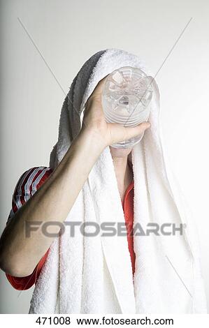 A man drinking from water bottle after exercising View Large Photo Image Stock Photo - A man drinking from water bottle after exercising. Fotosearch