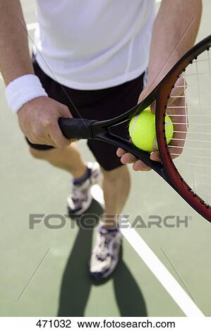 Stock Image - A man playing tennis. Fotosearch