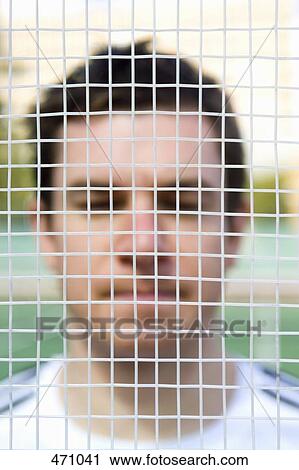 A man's face behind a tennis racquet View Large Photo Image Stock Image - A man's face behind a tennis racquet. Fotosearch