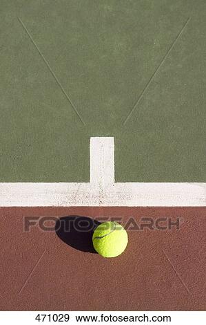 A tennis ball lying on a tennis court View Large Photo Image Stock Photo - A tennis ball lying on a tennis court. Fotosearch