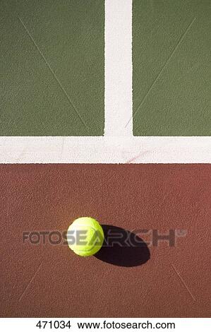 A tennis ball on a tennis court View Large Photo Image Picture - A tennis ball on a tennis court. Fotosearch