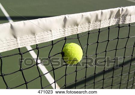 A tennis ball stuck in a tennis net View Large Photo Image Stock Image - A tennis ball stuck in a tennis net. Fotosearch