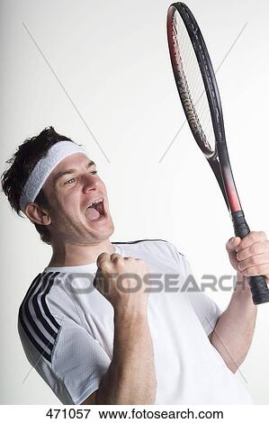 Stock Photo - A tennis player celebrating. Fotosearch