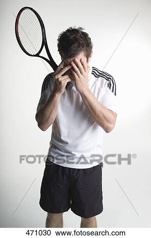 A tennis player covering his face with his hands View Large Photo Image Stock Image - A tennis player covering his face with his hands. Fotosearch