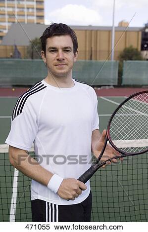 A tennis player standing on the court View Large Photo Image Stock Photography - A tennis player standing on the court. Fotosearch
