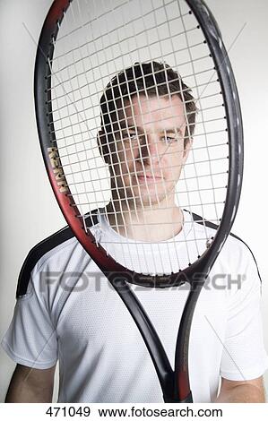 A tennis playing holding his tennis racquet in front of his face View Large Photo Image Stock Photo - A tennis playing holding his tennis racquet in front of his face. Fotosearch