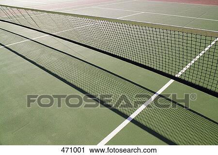 Stock Image - Shadow from a tennis net on a tennis court. Fotosearch
