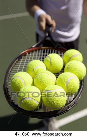 Tennis balls balancing on a tennis racquet View Large Photo Image Stock Image - Tennis balls balancing on a tennis racquet. Fotosearch